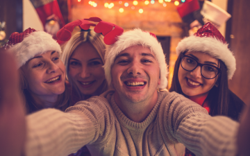 Group of friends taking a selfie in festive wear