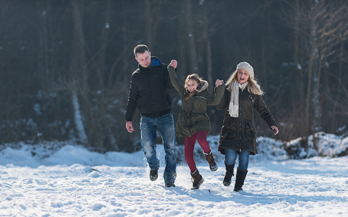 Family playing in snow 